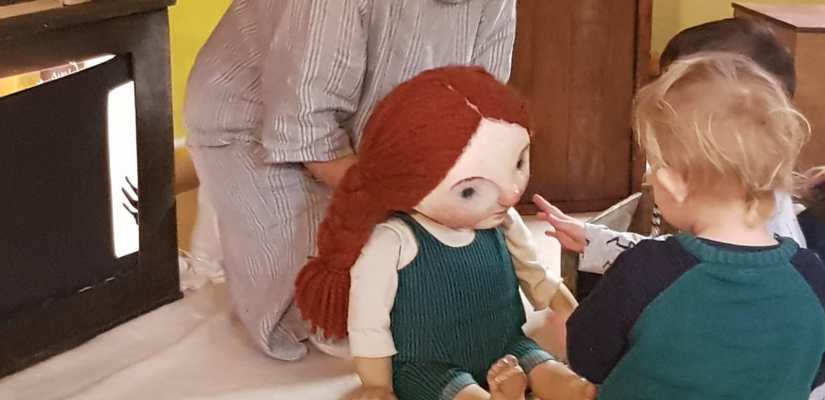 Young children meeting a puppet of a young girl. Ruth Boycott-Garnett